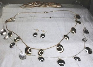 lot 218 image: Metal jewelry selection. Includes CZ bangle bracelets in gold finish and necklaces (gold and silver finish). Silver has matching ear wire earrings. 28L