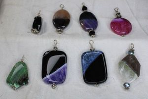 lot 227 image: (8) Banded Agate stone pendants. Includes Purple Agate, Amethyst in Black Agate plus. About 2H