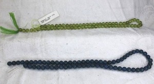 lot 230 image: Peridot 5MM round beads and dark blue translucent beads.