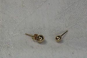 lot 250 image: 14K yellow gold stud ball earrings. Both posts marked 14K. One has indentation. One butterfly back marked 14K
