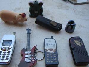 lot 211 image: lot of various Zippos pig,frog,phones, guitars, bear claw