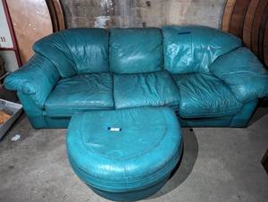 lot 17 image: Green Leather Sofa (39x93x32) and Ottoman (26x34 12x17)