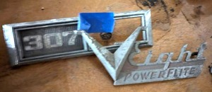 lot 407 image: 1954 Dodge V8 Emblem and 1968-1969 Chevrolet Chevelle 307 V8 Bezel