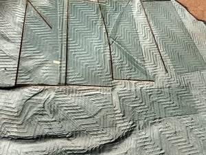 lot 253 image: Glass Pannels Wrapped In Blankets