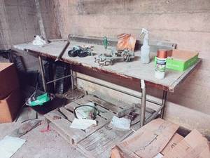 lot 365 image: Chopping Block Table and All Contents Including Wheels, Lamp, Sheets, Pillows, Wood, Scrap Metal, Commercial Drain Extentions, and MORE...
