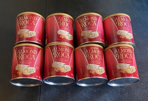 lot 295 image: Lot Of 8 - New Brown & Haley Almond Roca Cannister, The Original Buttercrunch Toffee With Almonds, 10 Oz Per Container - As Shown - Total Retail $120