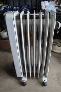 lot 130 image: Rolling Electric Radiator Heater, 110-Volt