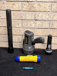 lot 247 image: Lot of Five (5) Assorted Flashlights - Including Brinkmann Dual Size Security Flashlight, Stanley Spotlight, Vintage Vought Aircraft, &amp Pocket Size Mag Light