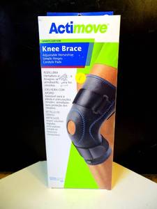 lot 1 image: NEW - Actimove Knee Brace Wrap Around Sports Edition Latex Free Black MEDIUM