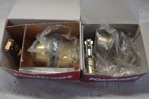 lot 21 image: Kwikset 665 DBL Deadbolt Polished Brass and 665 DBL Deadbolt in Antique Brass