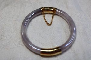lot 52 image: Well crafted Lavender Jade glass bangle with gold finish fittings and safety chain, Made to resemble Lavender Jade. Tests as glass.