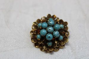 lot 54 image: Vintage Victorian Revival Turquoise Czech glass broochpin with intricate gold finish mount and pendant bale. 1.25W. Circa 1960s.