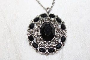 lot 61 image: Garnet glass pendant on silver finish necklace. 26L with 3 extender. Pendant 2L