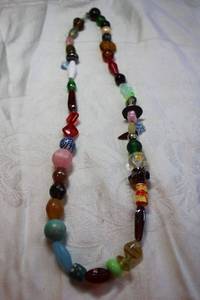 lot 63 image: Artisan crafted glass and mixed material bead necklace with fish, leaf and blue & white ball bead stations plus. Lobster clasp. 24L