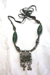 lot 72 image: Ethnic artisan crafted tin pendant necklace with hand painted satin glass tube satellite beads on leather cord. 30L approx.