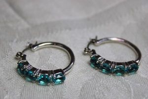 lot 76 image: Faux Blue Apatite prong set glass poststud earrings in silver finish. 1W