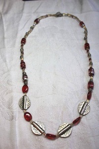 lot 82 image: Pewter color necklace with figural leaf and art glass red beads with silver accents. Toggle clasp. 18L
