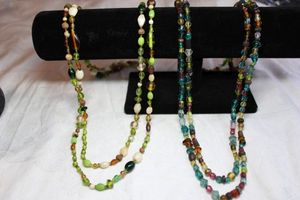 lot 83 image: (2) Vintage multi color glass and wood bead continuous rope necklace in vintage 1970s era color scheme. 58L and 54L
