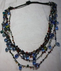 lot 86 image: Multi color multi strand glass bead string choker necklace with bead closure. 14L