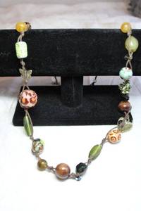 lot 97 image: Glass bead and mixed material bead station necklace with butterfly and heart dangles. Lobster clasp. 28L with 3 extender.