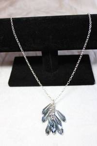 lot 103 image: Silver finish cable chain necklace with faceted blue iridescent pendulum glass dangles. 32L with 2 extender.