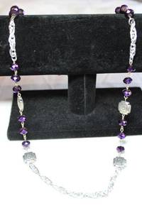 lot 104 image: Faceted purple glass bead and Southwestern motif style bead silver finish necklace. 24L with lobster clasp.