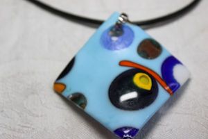 lot 152 image: Incredibly detailed case Dichroic glass modernist style twisted glass pendant on 14L leather cord necklace. Lobster clasp. 2.75L