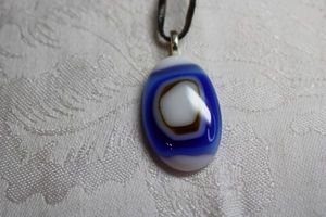 lot 160 image: Dichroic glass Bullseye pendant on 30 corded necklace. Pendant 1.75L