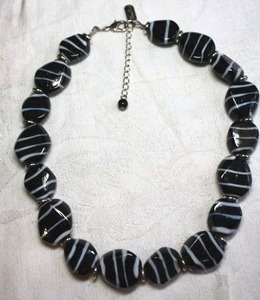 lot 163 image: Signed Hilary London ( Hilary Foster, New York, 1986 - 2007 approx , known for Murano jewelry ) Murano Glass Black & White lampwork bead necklace. Has hang tag. 14L with 2 extender. Lobster clasp.