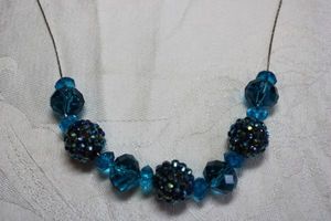 lot 168 image: Faceted blue glass and blue pave crystal slide beads on silver finish necklace. 16L with 3 extender. Lobster clasp.