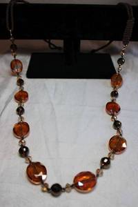 lot 170 image: Autumnal color orange and brown faceted bead necklace with braided silk brown yoke. Lobster clasp. 38L with 3 extender