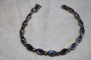 lot 111 image: Vibrant marquise cut Swiss blue glass, London blue glass and Tanzanite purple glass bracelet. Tests as glass. Has IS mark. Box clasp with safety hook. 8L