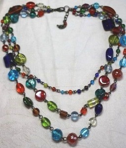 lot 114 image: Vintage multi color and shape glass bead necklace on metal chain. 16L with 2 extender. Lobster clasp.