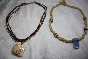 lot 118 image: Multi strand micro glass bead 16L boho necklace with ceramic ivory square pendant. Lobster clasp. Includes a woven raffia necklace with glass pendant and clay station beads. 16L with bead closure.