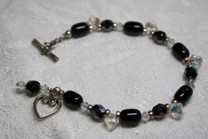 lot 125 image: Black and AB crystal bracelet with heart shape toggle clasp. 6.5L. Marcasite decorated toggle bar.