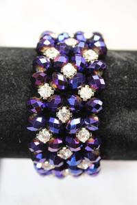 lot 172 image: Vibrant color purple faceted bead and prong set crystal bead stretch bracelet. 1.25W