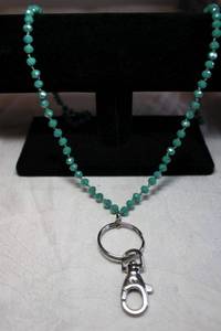 lot 176 image: Faceted green glass bead continuous necklace with keychainoversize lobster clasp to use as lanyard. Can be doubled to use as necklace. Be the envy of your next convention. 30L