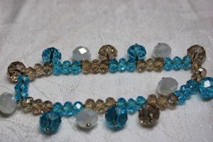 lot 180 image: Faceted champagne, medium blue and white dangle bead stretch bracelet