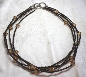 lot 201 image: Glass microbead 4-strand chokernecklace with faceted champagne station beads and hook clasp. 14L
