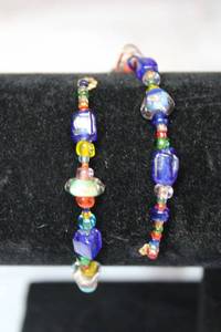 lot 207 image: Wire spiral wraparound youth size bracelet with glass beads.