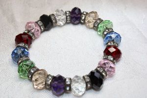 lot 219 image: Faceted multi color glass bead stretch bracelet with rhinestone separator collars.