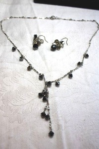 lot 225 image: Silver finish Y- necklace with faceted black bead dangle stations and magnetic clasp. 18L. Includes complementing faceted black and clear glass cluster ear wire earrings. Earrings 1.25L
