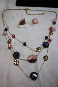 lot 232 image: Gold finish triple strand necklace with marbled purple swirl disc and freeform shell beads. Includes a pair of ear wire matching shell earrings. 18L with 3 extender. Earrings 1.5H