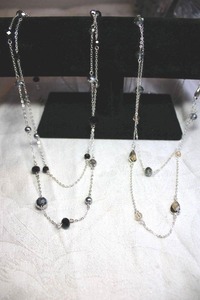 lot 233 image: (2) Silver finish double strand necklace with smokey glass stations. 26L with 3 extender. Lobster clasp. One marked NWT (Avon)