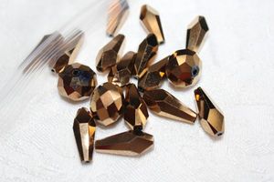 lot 234 image: Copper metallic faceted Aroura Borealis AB beads. Round and dagger shapes.