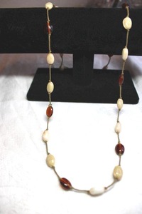 lot 235 image: Custard glass station bead continuous 30L necklace in cream and red.