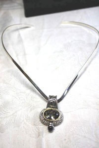 lot 237 image: Faceted East-West oriented Smokey Glass pendant with large bale on 14L silver torque necklace.