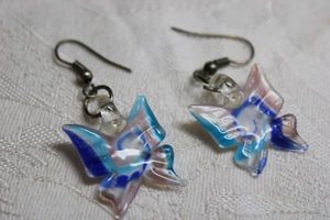 lot 241 image: Figural glass ear wire earrings in butterfly form. 1.5L