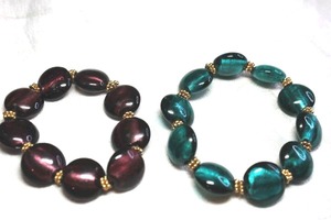 lot 245 image: (2) Foil crackle glass oval bead stretch bracelets with gold spacers. Teal green and Merlot purple.