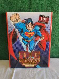lot 40 image: DC comic book guide with Superman on hard cover